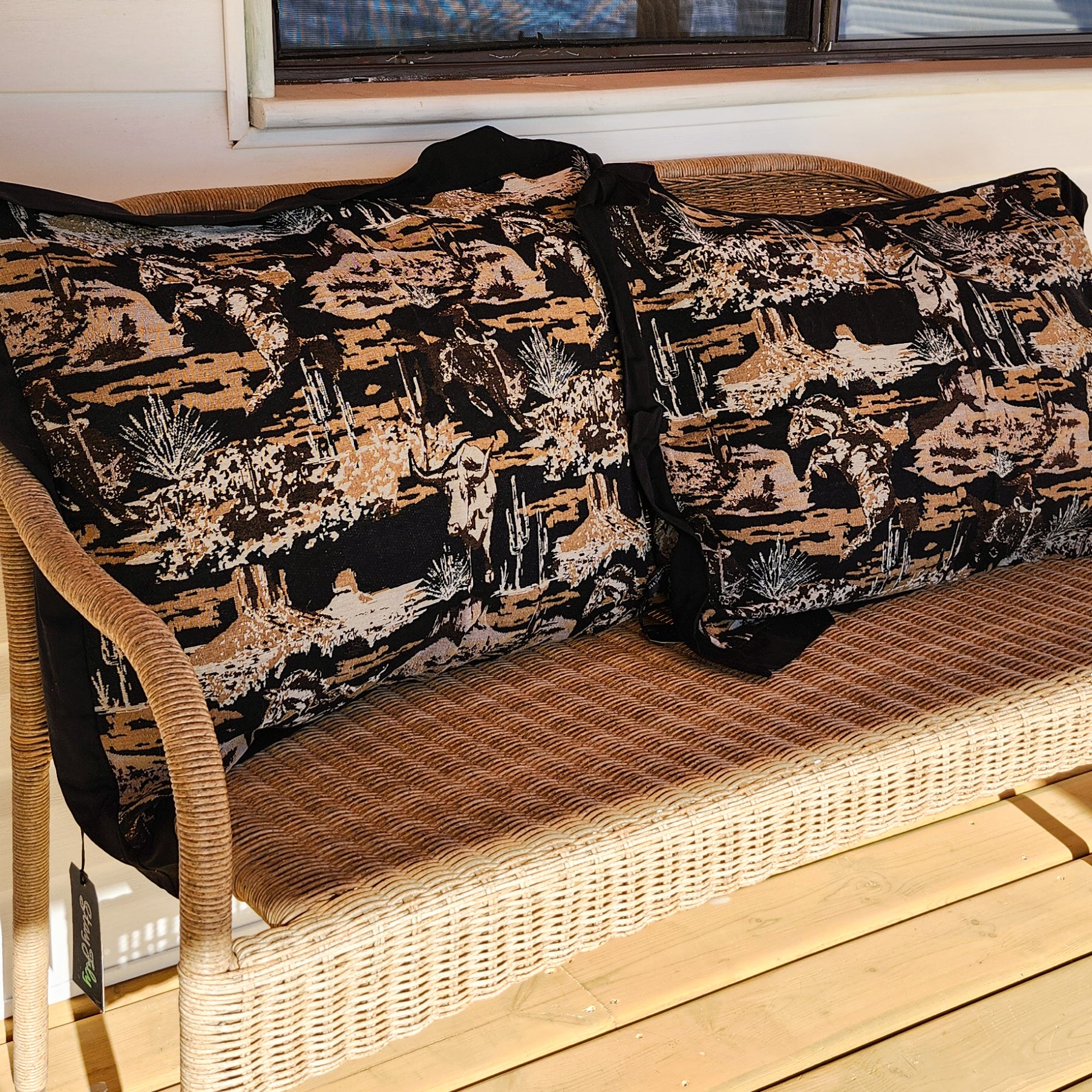 Set of 2 western jacquard tapestry pillowcases on woven wicker bench, black and tan textured fabric with desert-inspired pattern